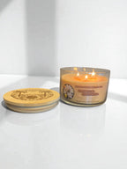 Lit tropical gardenia candle and the lid resting to the side