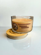 Lid sitting underneath the tropical gardenia three wick candle