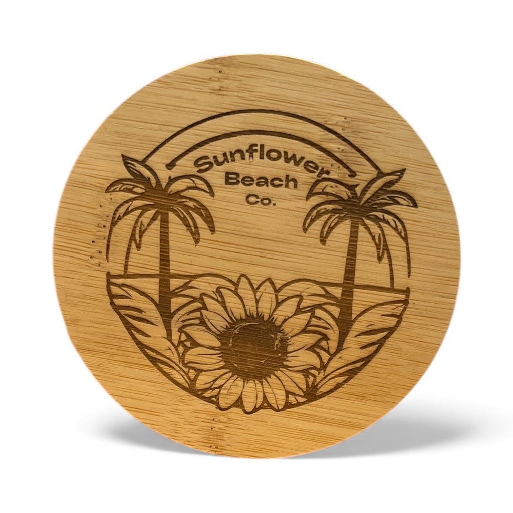 Wooden coaster with sunflower and palm tree design and 'Sunflower Beach Co.' branding.
