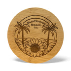 Wooden coaster with sunflower and palm tree design and 'Sunflower Beach Co.' branding.