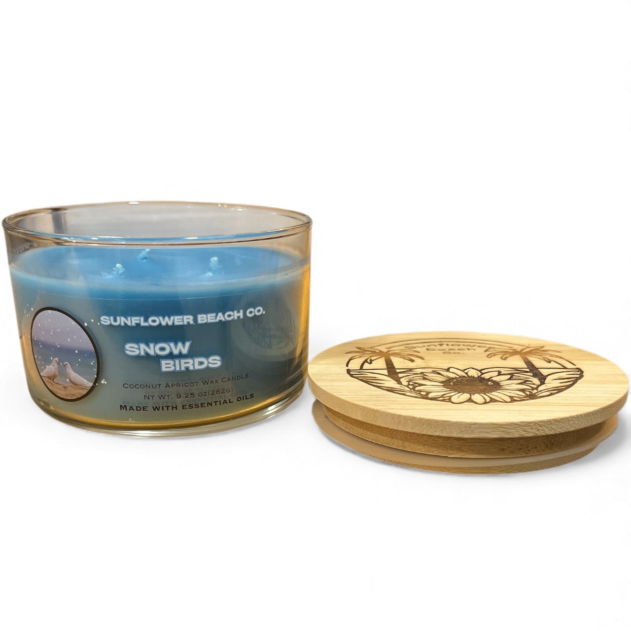 Candle with a wooden coaster on a white background