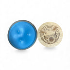 Blue candle in a tin with a wooden lid featuring a sunflower design on a white background