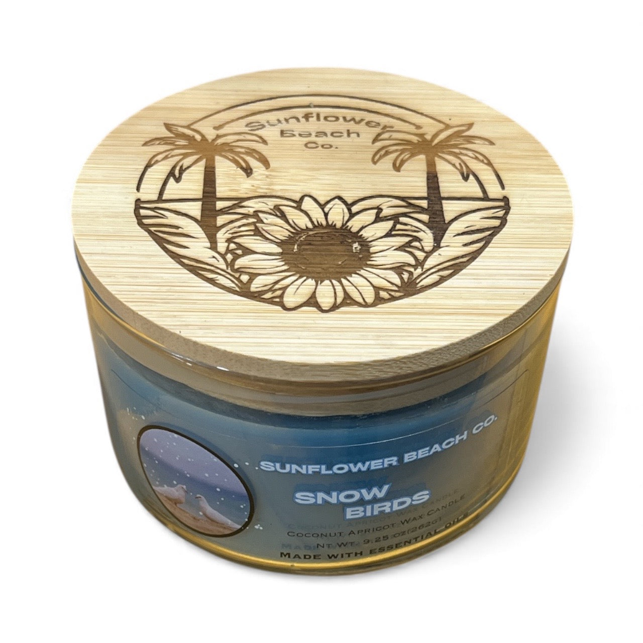 Jar with wooden lid featuring sunflower and palm tree design, labeled 'Sunflower Beach Co'.