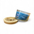 Candle with wooden lid and Sunflower Beach Co. label on a white background