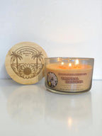 Showcasing the bamboo engraved lid with the sunflower beach logo and tropical gardenia three wick candle