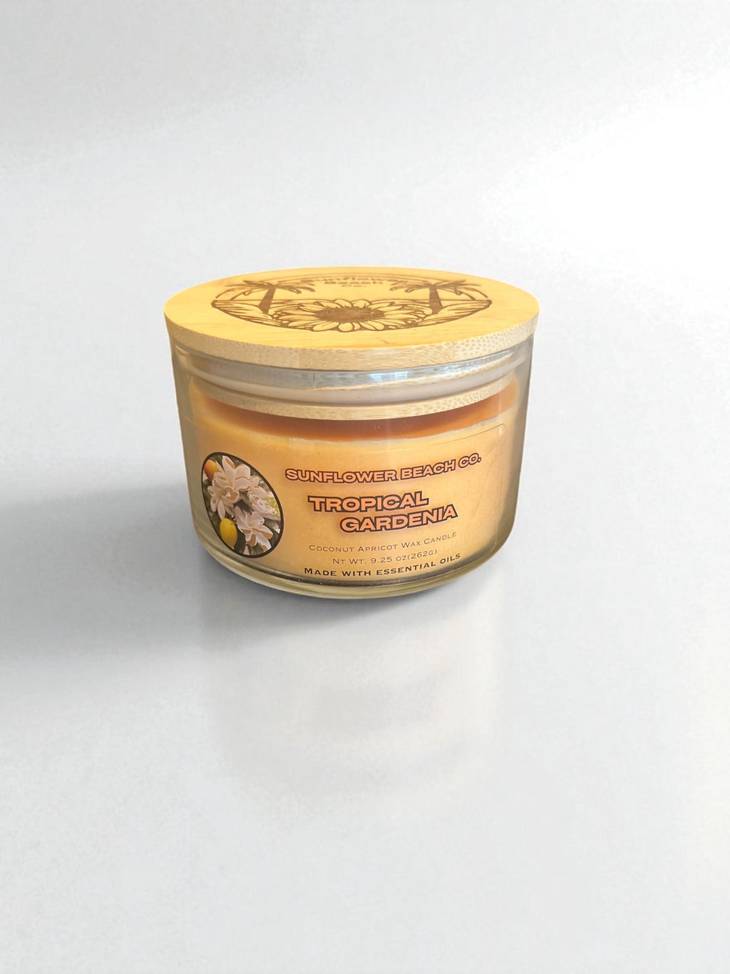 Bamboo lid on top of a tropical gardenia three wick essential oil candle