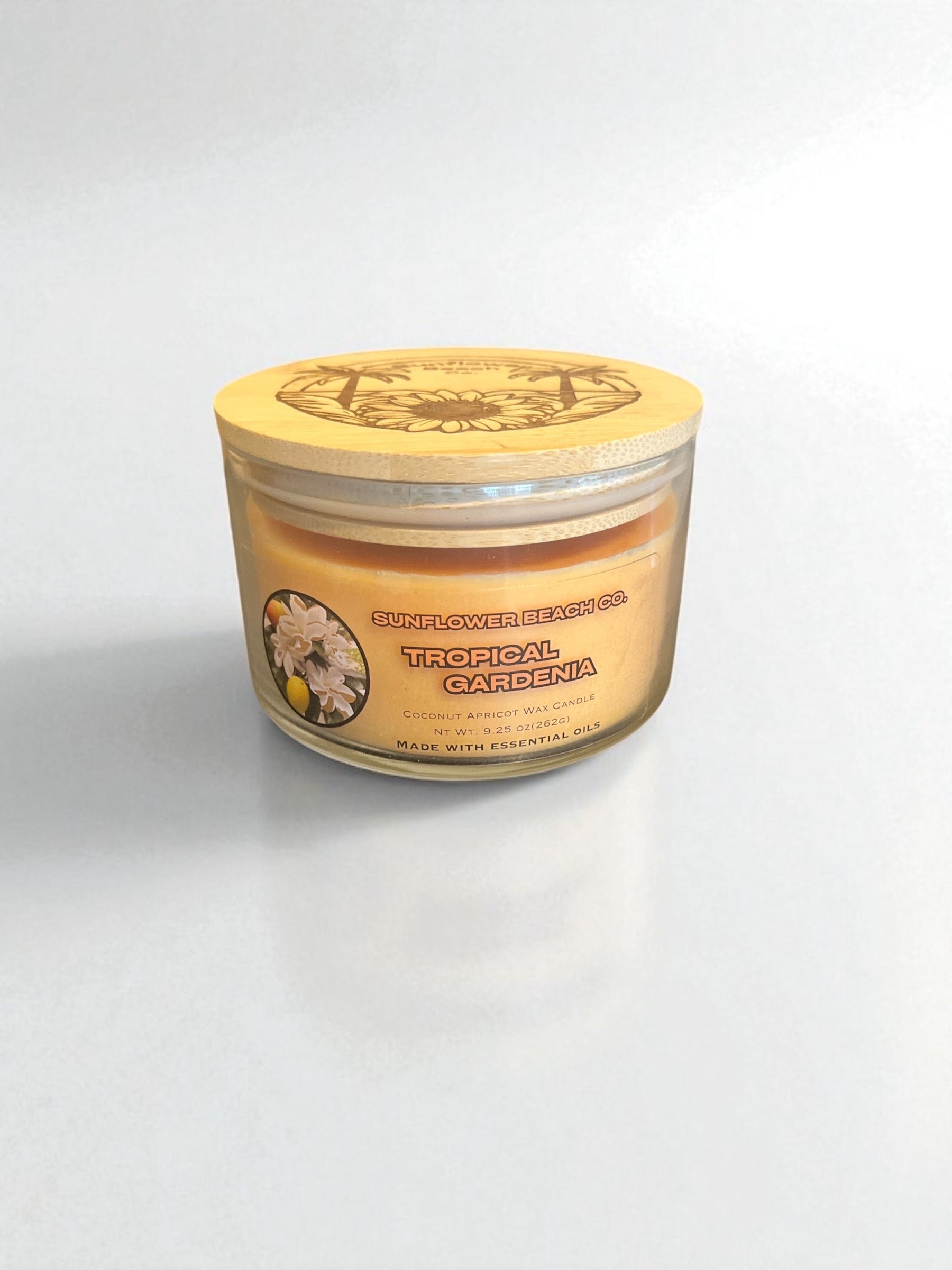 Bamboo lid on top of a tropical gardenia three wick essential oil candle